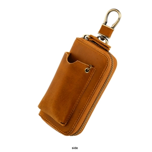 Side view of caramel brown leather key pouch with vintage brass zipper and spring hook