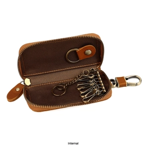 Close-up of brown leather key pouch interior with six vintage bronze metal hooks
