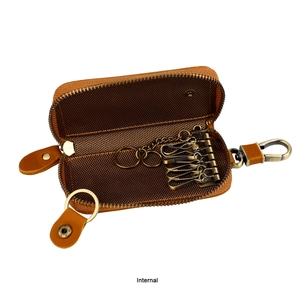 Internal view of brown leather key case with six vintage bronze metal hooks and chain