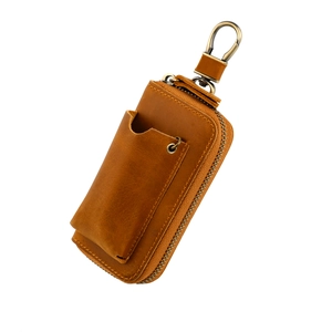 Genuine brown leather car key bag with brass hardware and zipper closure on white background