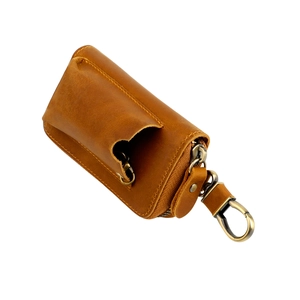Brown vintage leather car key case with metal zipper and hook on white background