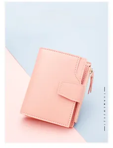 Detail of light pink PU leather wallet with snap button closure and side metal zipper pocket