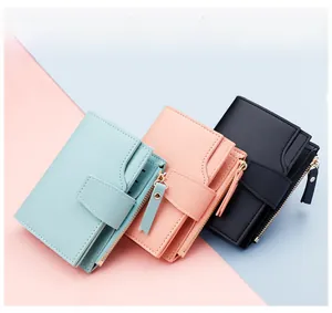 Three-fold women's wallets in light blue, pink, and black with gold snap buttons