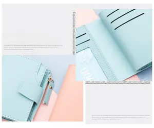 Detail of light blue tri-fold wallet showing multiple card slots and zipper pocket