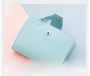 Detail of mint green PU leather trifold wallet with snap button and decorative strap