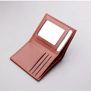 Detailed interior of brown bifold wallet showing card slots and orange contrast stitching