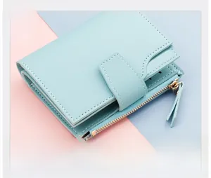 Detail of light blue tri-fold wallet showing multiple card slots and side zipper pocket