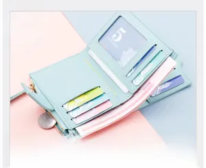 Detail of light blue tri-fold wallet showing card slots, photo window and coin pocket