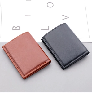Detailed view of black and brown leather card holders with pebbled texture and neat stitching