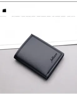 Detailed close-up of men's black lychee grain leather wallet with precision stitching