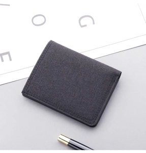 Macro view of dark grey canvas wallet with fine stitching and modern fabric texture