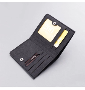 Detailed view of dark grey canvas wallet with multiple card slots and zipper pocket