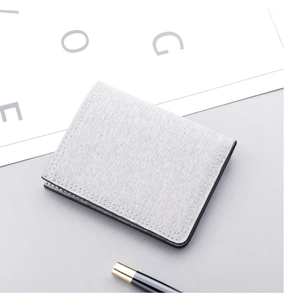 Detailed view of grey canvas wallet featuring fine linen texture and durable stitching