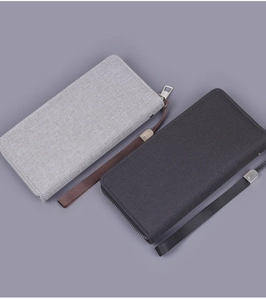 Top view of canvas zipper clutches in grey and black with sturdy wrist straps