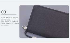 Detail of durable black canvas clutch featuring secure zipper and sturdy wrist strap