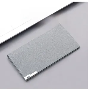 Detail of grey canvas long wallet with silver metal trim and fine stitching craftsmanship