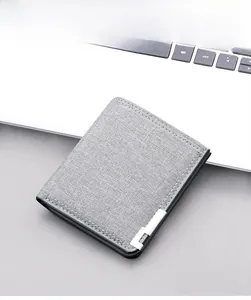 Close-up of slim grey canvas wallet for men featuring minimalist metallic detail in office setting