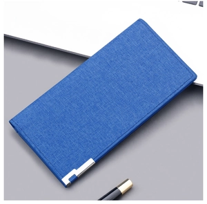 Detailed blue canvas long wallet with linen texture and metal trim in a business setting