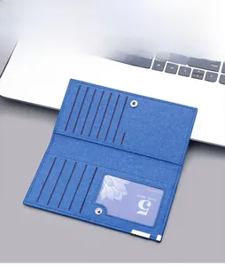 Detail view of blue canvas long wallet showing multi-card slots and secure snap closure