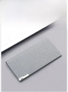 Gray long canvas wallet with L-shaped metal clip detail in a modern desk office setting