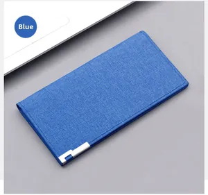 Close-up of the long blue canvas wallet with silver metal corner and fine stitching detail