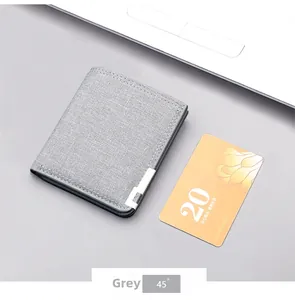 Close-up of minimalist grey canvas wallet with neat stitching and metal decor detail