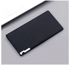 Detailed view of black slim canvas wallet with woven texture and silver metal clasp detail