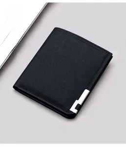 Macro detail of slim black canvas bifold wallet with silver metal emblem and stitching