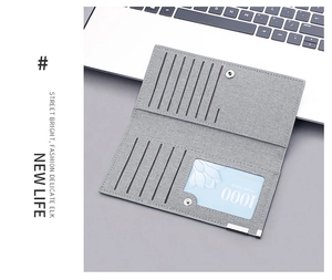 Detail of gray canvas wallet interior featuring multiple card slots and metal snap closure