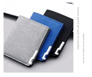 Detail of slim canvas wallets in grey, blue and black with stylish metal corner accents