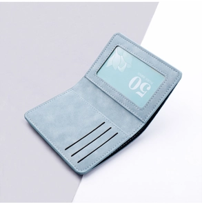 Macro shot of light blue slim card holder with three card slots and transparent ID window