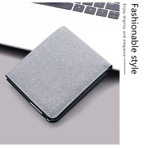 Detail of grey canvas wallet texture with fine stitching on a laptop background