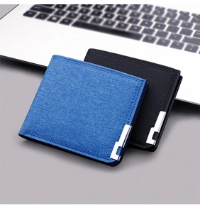 Detail of blue and black fabric men's wallets with metal corner and double stitching