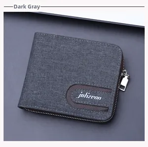 Close-up of a dark grey canvas wallet with zipper closure and white logo detail