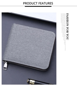Close-up of gray canvas zipper wallet with white stitching and metal hardware details