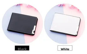 Detail view of textured PU leather wallets in black and white with metal corner accents