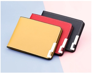 Detail of leather driving license covers in yellow, red, and black with metal corners