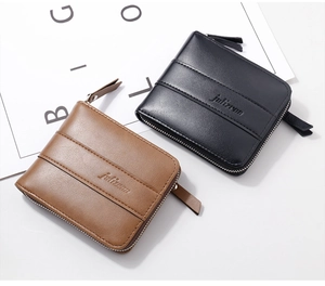 Detail view of leather texture and stitching on men's bifold zip wallet in black and brown