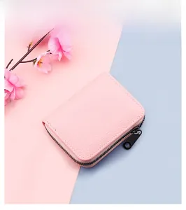 Pink lychee texture leather card holder with black metal zipper and elegant floral decor