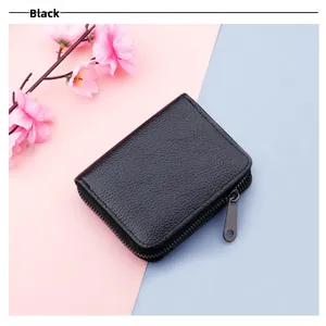 Macro view of black lychee grain leather card holder with secure metal zipper closure