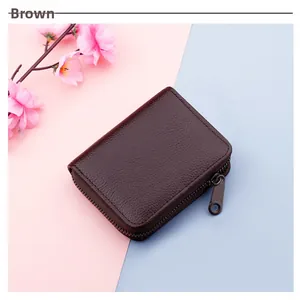 Detail of a brown lychee pattern leather card holder with secure wraparound metal zipper