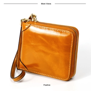 Détail du porte-monnaie vintage en cuir ciré avec zip doré et dragonne