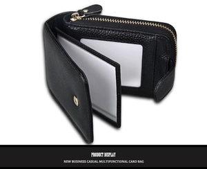 Macro detail of black litchi grain leather card holder with multiple PVC slots and metal snap
