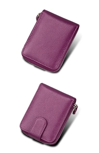 Macro view of purple lychee grain leather wallet showing premium texture and zipper detail