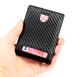 Slim carbon fiber wallet with RFID protection showing card slots and hand holding detail