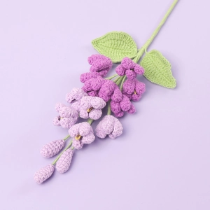 Detailed close-up of handmade crochet purple lilac bouquet with gradient knitted petals