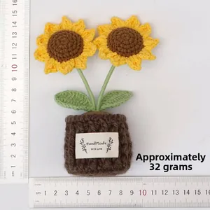 Macro detail of a handmade crochet sunflower potted plant showing textured yarn stitches