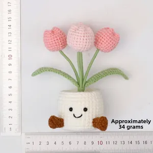 Detail of pink crochet tulip pot with a smiley face measuring 14cm in height