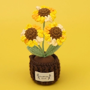 Detail of three handmade crochet sunflowers in a brown pot with HandMade text label