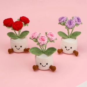 Handmade crochet sunflower potted plants in red pink and purple with smiling face designs